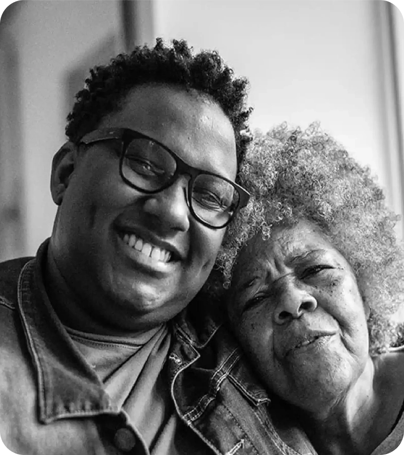 Smiling man taking a selfie with an elderly woman