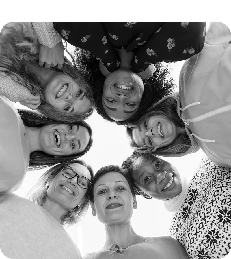 Group of smiling women looking down at the camera